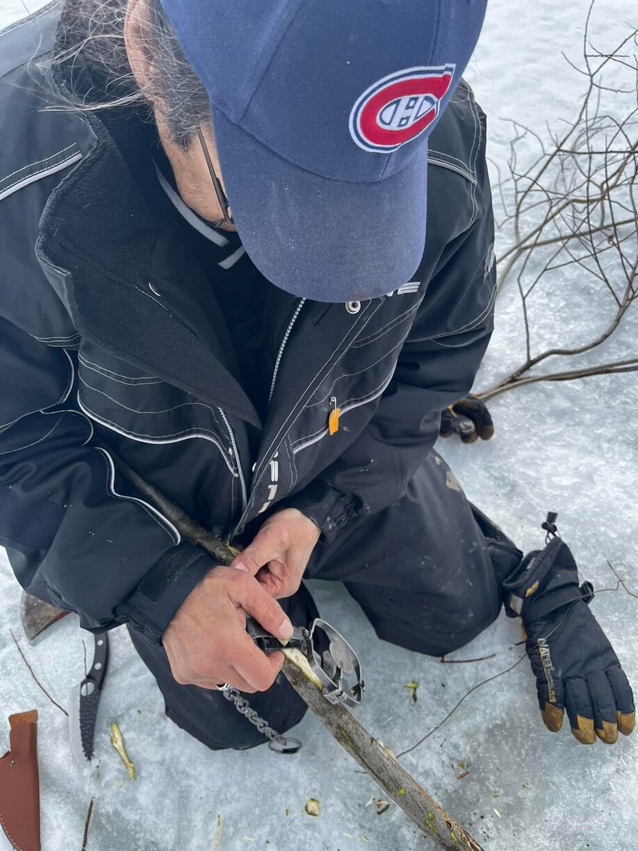 photo shows a man setting a trap