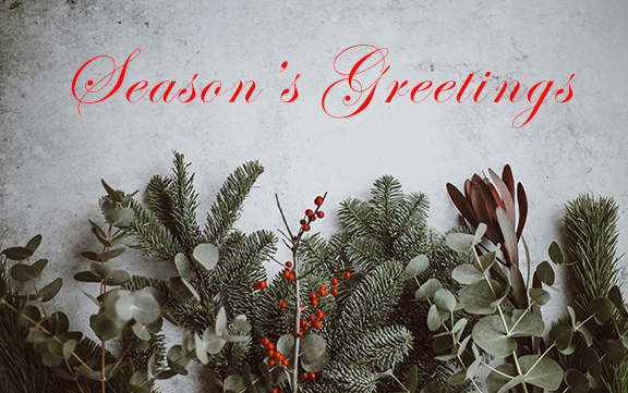 text reads 'Season's Greetings' in script red font. Background image is of sprigs of berries, eucalyptus and spruce branches.